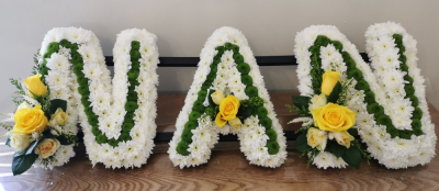 NAN tribute - A NAN tribute to remember a beloved grandparent. Massed in white with green to enhance the letter shape & finished with floral sprays. Can be designed in any colour choice