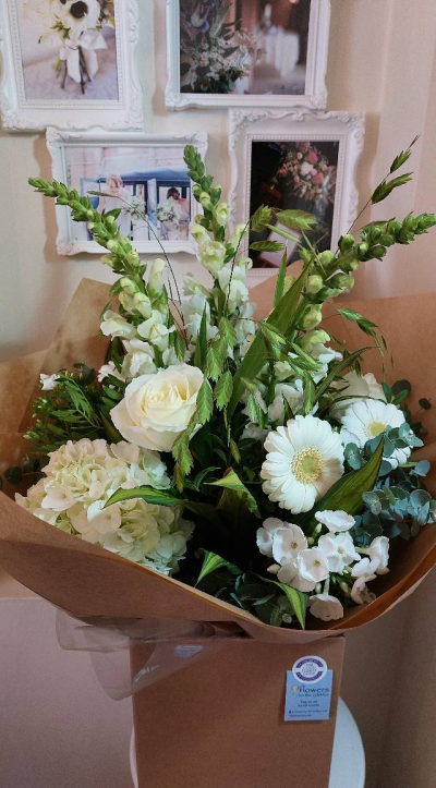 Evelyn - A fabulous collection of white and cream flowers make this the perfect gift. This bouquet will be hand delivered by the local florist.